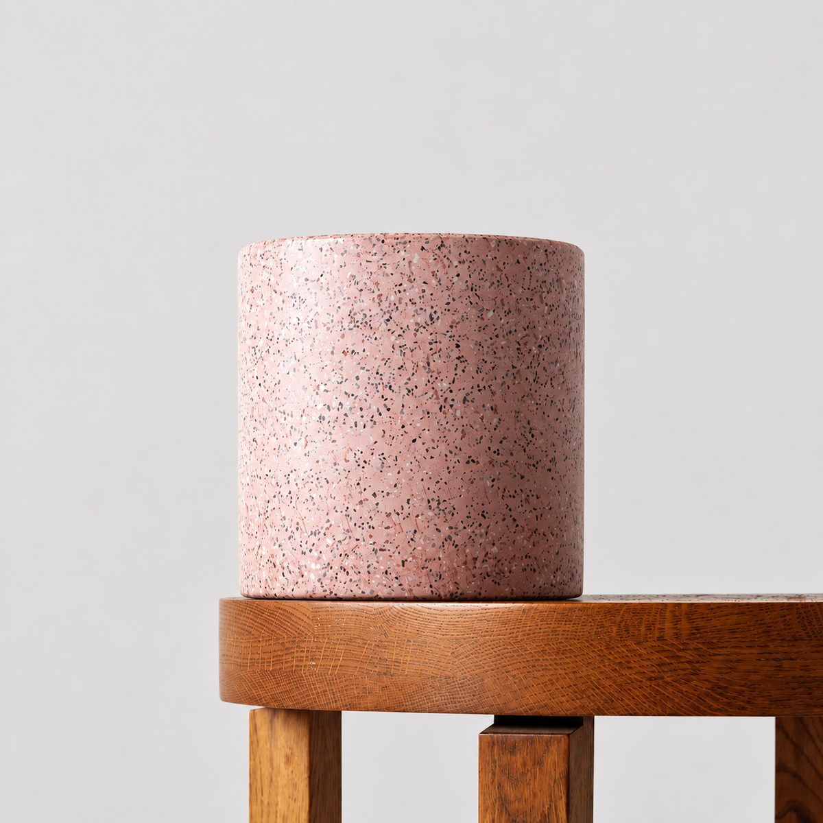 Jardin pink terrazzo pot on a timber table against a soft grey background.