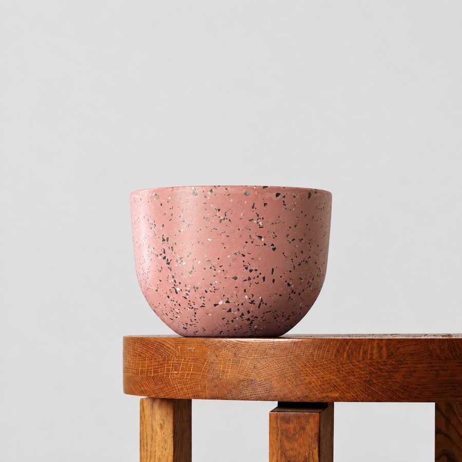 Pierre pink terrazzo pot on a timber table against a soft grey background.